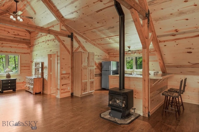 101 W Bridger Creek Rd, Big Timber, MT 59011 - additional living space with lofted ceiling, wooden walls, a wood stove, dark wood finished floors, and wood ceiling