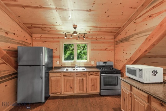 101 W Bridger Creek Rd, Big Timber, MT 59011 - kitchen featuring stainless steel appliances, a sink, dark wood finished floors, wood walls, and dark countertops