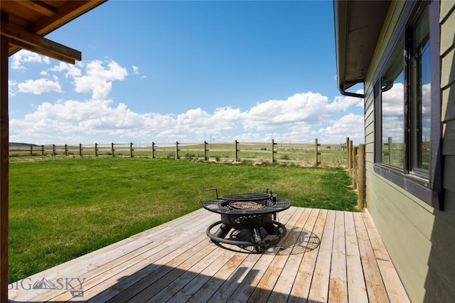 wooden terrace with an outdoor fire pit and a view of countryside