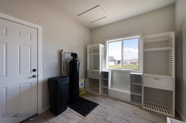 misc room featuring vaulted ceiling, baseboards, and light wood finished floors