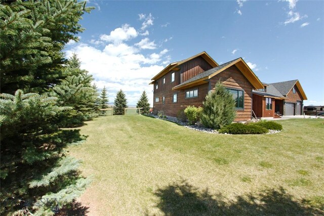 7 N Lewis And Clark Trl, Whitehall, MT 59759 - view of side of property with a garage, a lawn, and board and batten siding