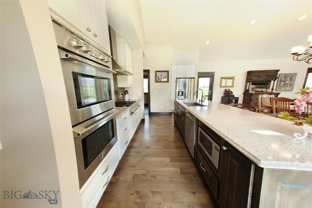 7 N Lewis And Clark Trl, Whitehall, MT 59759 - kitchen with stainless steel appliances, white cabinets, dark wood-style floors, a chandelier, and recessed lighting