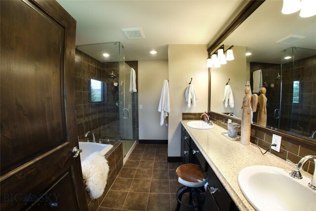7 N Lewis And Clark Trl, Whitehall, MT 59759 - bathroom featuring tile patterned flooring, double vanity, a stall shower, a bath, and tasteful backsplash