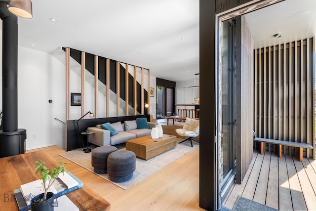 living room featuring wood finished floors, stairs, and recessed lighting