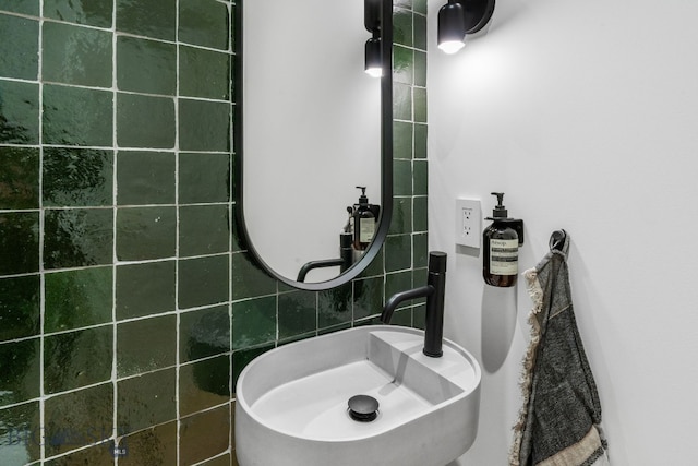 bathroom with a sink and tile walls