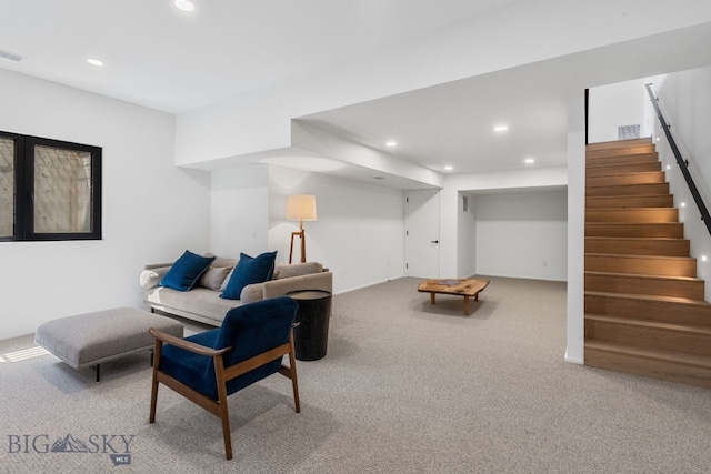 carpeted living area featuring recessed lighting and stairs