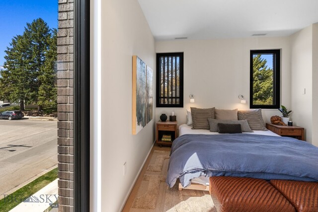 bedroom featuring wood finished floors and baseboards
