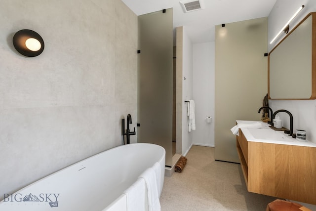 bathroom featuring a freestanding tub and vanity
