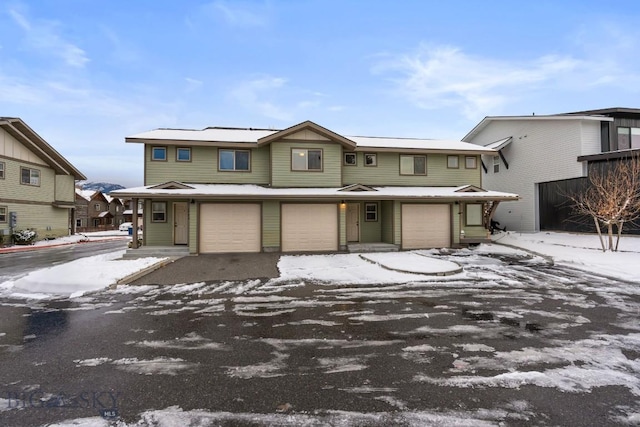 view of property featuring an attached garage and driveway