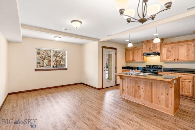 kitchen with electric range, under cabinet range hood, light brown cabinets, and baseboards