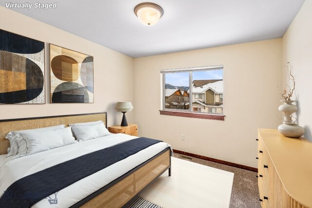 carpeted bedroom with baseboards