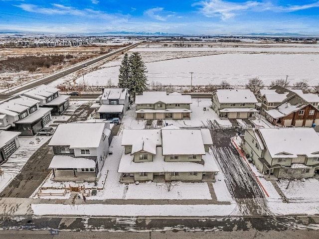 snowy aerial view with a residential view