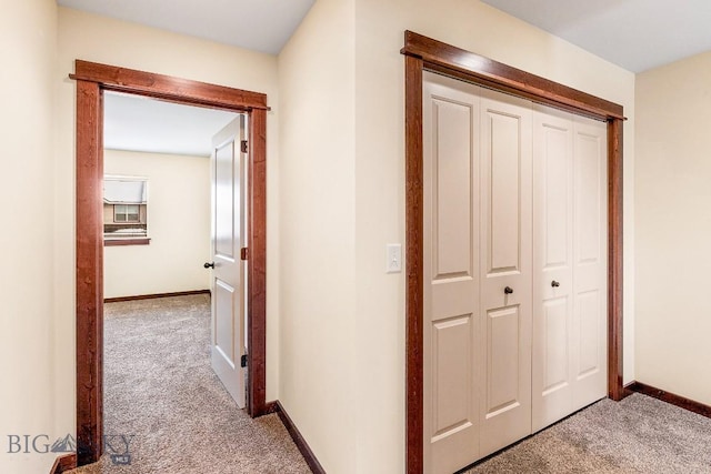 corridor with light colored carpet and baseboards