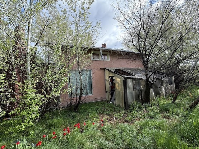 NHN S Pine St, Reed Point, MT 59069 - back of house featuring stucco siding and a chimney