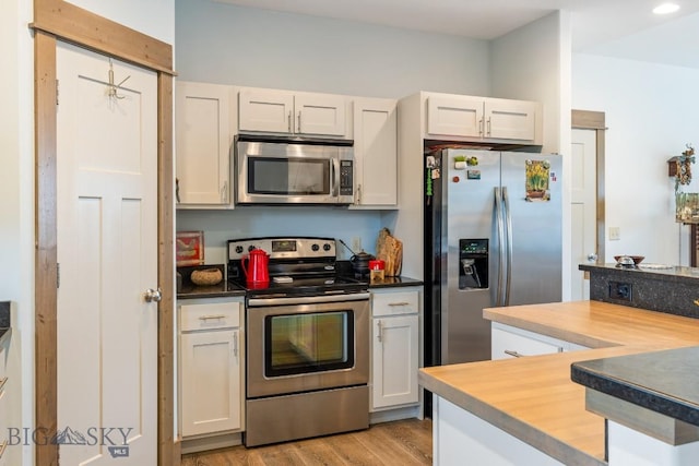 182 Snowy Owl Trl, Bozeman, MT 59718 - kitchen with appliances with stainless steel finishes, light wood-style floors, and white cabinetry