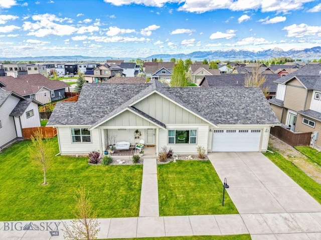 182 Snowy Owl Trl, Bozeman, MT 59718 - view of front of property featuring board and batten siding, a residential view, an attached garage, driveway, and a mountain view