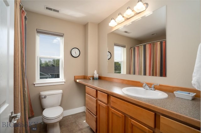 508 Coral Dr, Belgrade, MT 59714 - bathroom featuring vanity, tile patterned floors, toilet, and baseboards