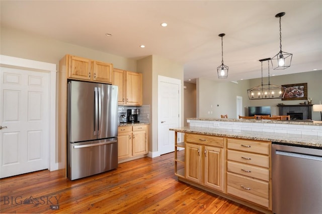 508 Coral Dr, Belgrade, MT 59714 - kitchen with stainless steel appliances, light brown cabinetry, dark wood-style floors, recessed lighting, and decorative backsplash