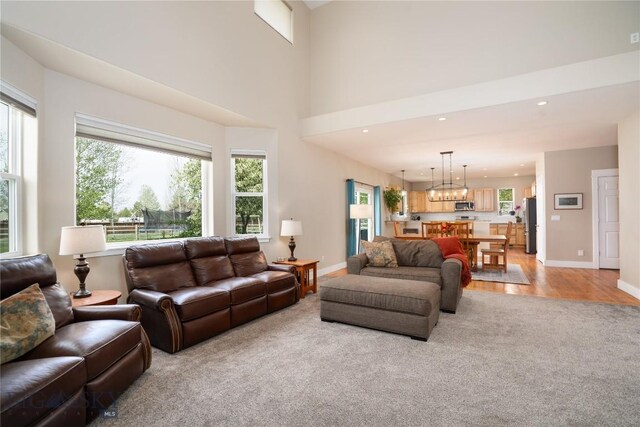508 Coral Dr, Belgrade, MT 59714 - living room with light colored carpet, healthy amount of natural light, baseboards, and recessed lighting