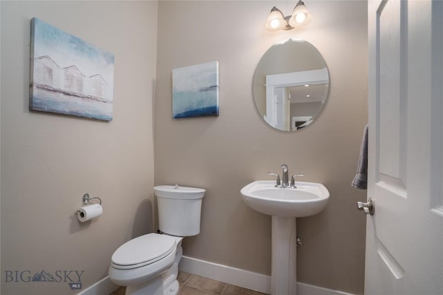 508 Coral Dr, Belgrade, MT 59714 - bathroom featuring toilet, baseboards, and a sink