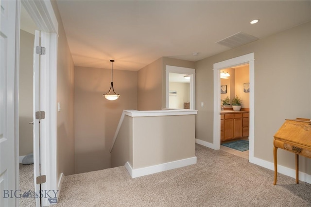 508 Coral Dr, Belgrade, MT 59714 - corridor featuring an upstairs landing, light carpet, and baseboards