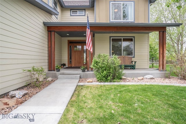508 Coral Dr, Belgrade, MT 59714 - entrance to property featuring covered porch, board and batten siding, and a lawn