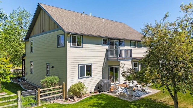 508 Coral Dr, Belgrade, MT 59714 - rear view of house with a balcony, board and batten siding, a patio, and a shingled roof
