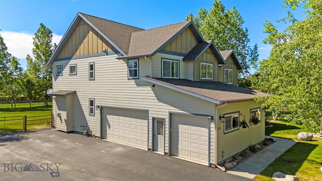 508 Coral Dr, Belgrade, MT 59714 - view of front facade featuring board and batten siding, roof with shingles, and an attached garage
