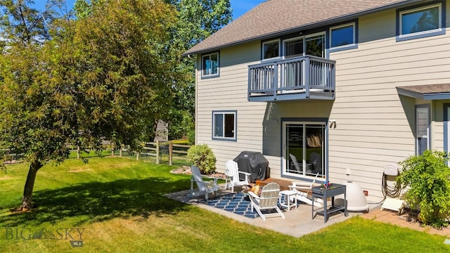 508 Coral Dr, Belgrade, MT 59714 - rear view of house featuring a balcony, a patio area, and a shingled roof