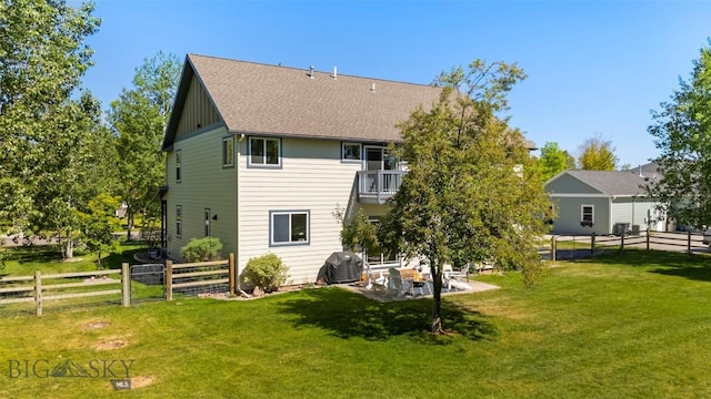 508 Coral Dr, Belgrade, MT 59714 - back of house with a balcony, a patio, and roof with shingles
