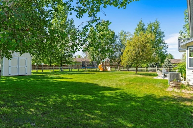 508 Coral Dr, Belgrade, MT 59714 - view of yard featuring a playground, a trampoline, and central air condition unit