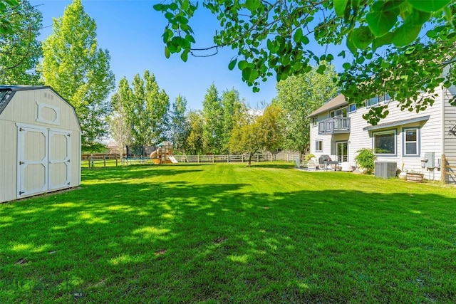 508 Coral Dr, Belgrade, MT 59714 - view of yard featuring a playground, central air condition unit, and a balcony