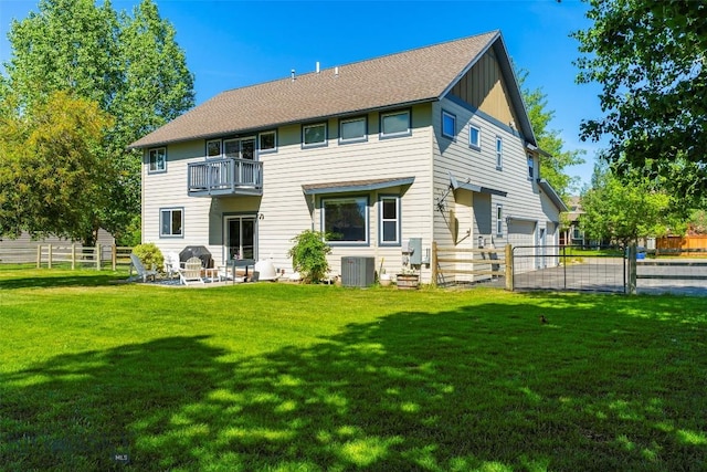 508 Coral Dr, Belgrade, MT 59714 - back of property featuring a balcony, an attached garage, cooling unit, and board and batten siding
