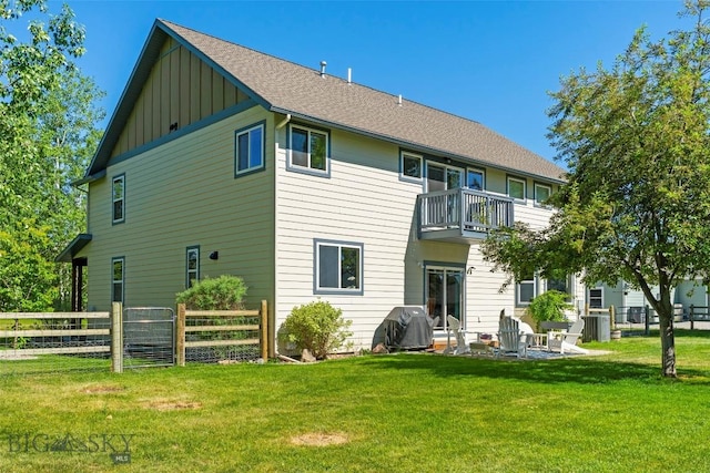 508 Coral Dr, Belgrade, MT 59714 - rear view of house featuring board and batten siding, a balcony, and a shingled roof