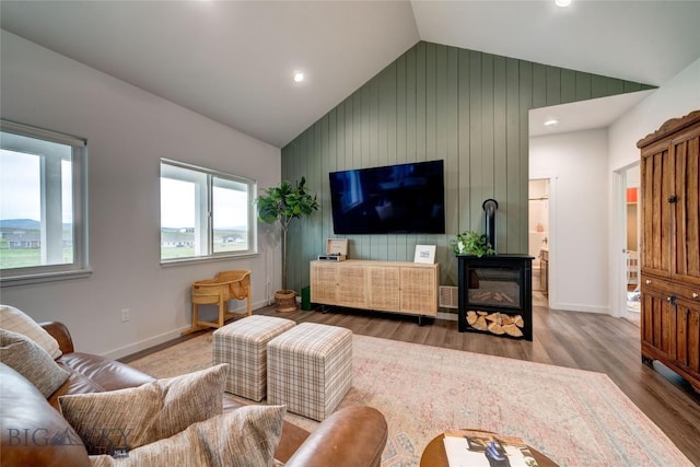 36 Sante Fe, Three Forks, MT 59752 - living room featuring lofted ceiling, wood finished floors, baseboards, recessed lighting, and a glass covered fireplace