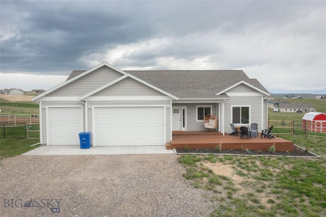 36 Sante Fe, Three Forks, MT 59752 - view of front of house with gravel driveway, roof with shingles, a garage, and a wooden deck