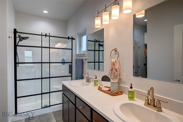 36 Sante Fe, Three Forks, MT 59752 - full bathroom featuring tiled shower, double vanity, and wood finished floors