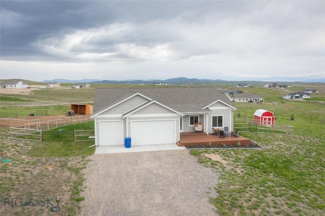36 Sante Fe, Three Forks, MT 59752 - ranch-style house featuring driveway, an attached garage, and a mountain view