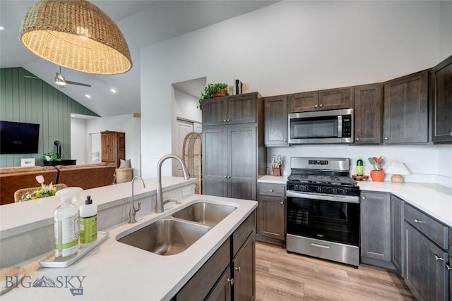 36 Sante Fe, Three Forks, MT 59752 - kitchen featuring stainless steel appliances, a sink, vaulted ceiling, light countertops, and light wood finished floors
