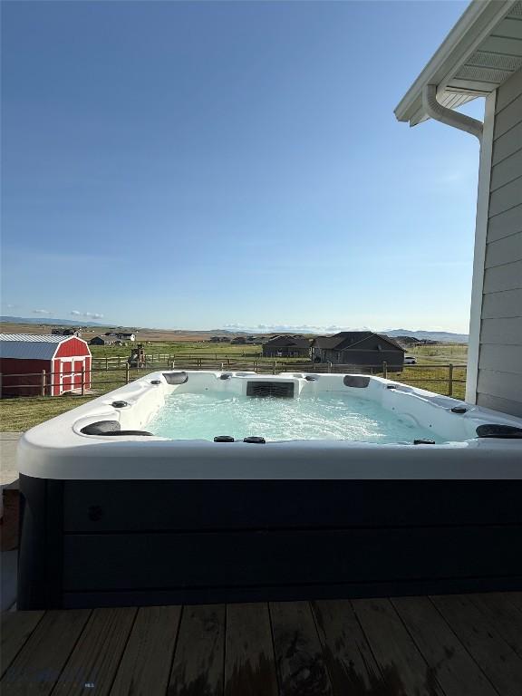 36 Sante Fe, Three Forks, MT 59752 - view of pool with a hot tub, a wooden deck, and a storage unit