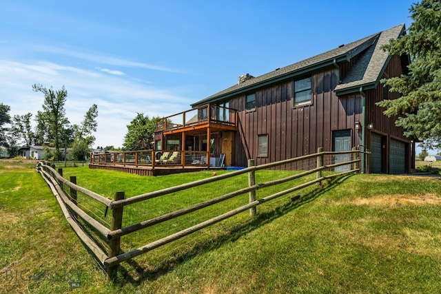 9704 River Rd, Bozeman, MT 59718 - back of property with a chimney, a yard, a wooden deck, board and batten siding, and a shingled roof