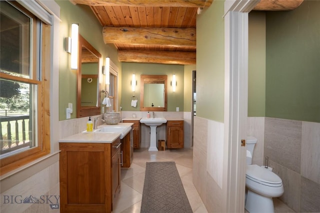 9704 River Rd, Bozeman, MT 59718 - full bathroom featuring wooden ceiling, beam ceiling, a wainscoted wall, tile patterned floors, and tile walls