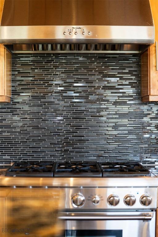 9704 River Rd, Bozeman, MT 59718 - kitchen view of high end stainless steel range, backsplash, and exhaust hood