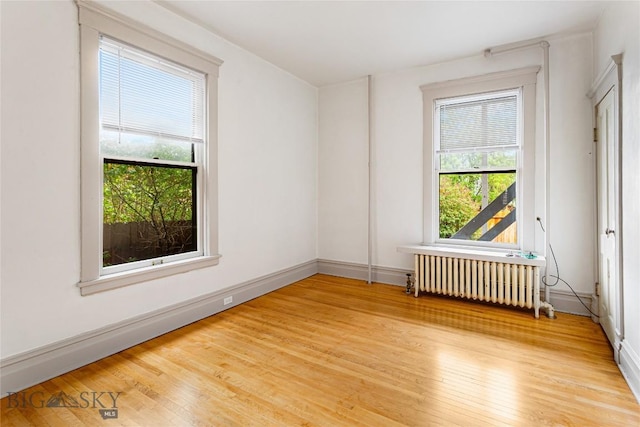 822 W Park St, Butte, MT 59701 - spare room featuring radiator heating unit, light wood-style floors, and baseboards