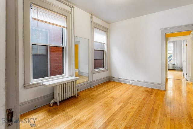 822 W Park St, Butte, MT 59701 - empty room with radiator, healthy amount of natural light, and light wood-style flooring