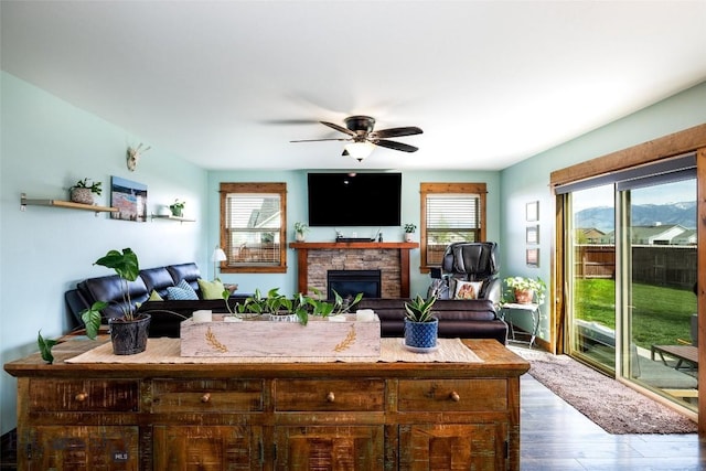 1602 Ingomar Blvd, Belgrade, MT 59714 - living room featuring a fireplace, ceiling fan, and wood finished floors