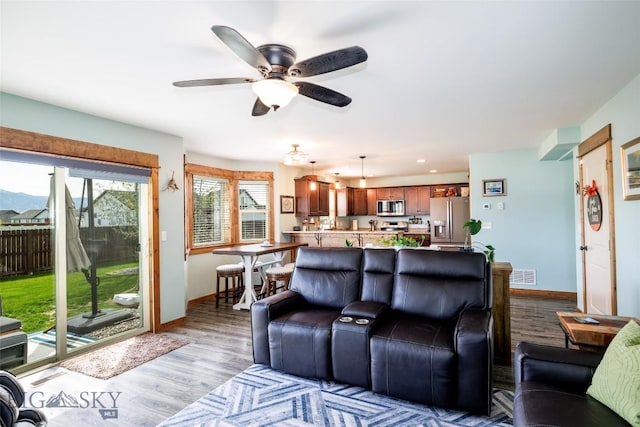 1602 Ingomar Blvd, Belgrade, MT 59714 - living area with wood finished floors, a ceiling fan, baseboards, and recessed lighting