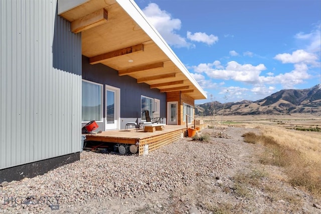 rear view of property featuring a deck with mountain view