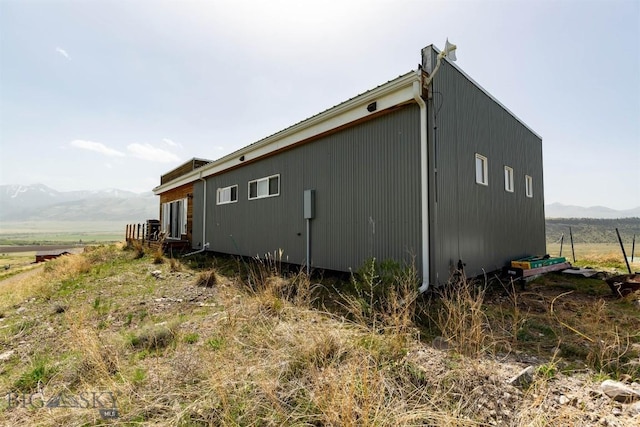 view of property exterior with a mountain view