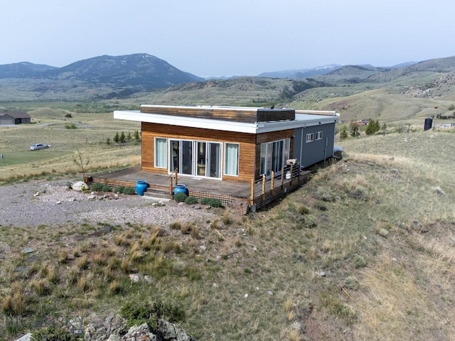 rear view of property with a deck with mountain view